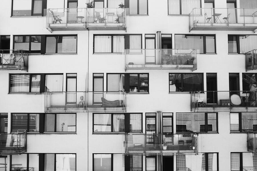 A grid of apartment windows across a building face